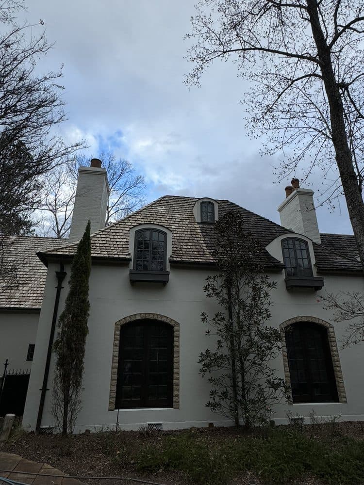 White stucco home with cedar shake roof after a house and roof wash, Birmingham metro