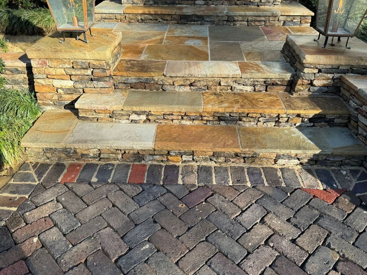 Flagstone steps, stacked stone walls and a brick paver walk after cleaning, gas lanterns lit, Birmingham metro