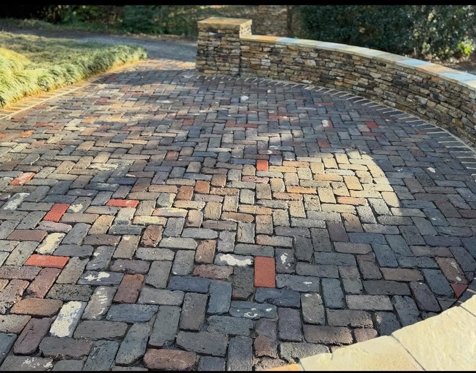 Herringbone brick paver patio inside a stone wall after cleaning, Birmingham metro