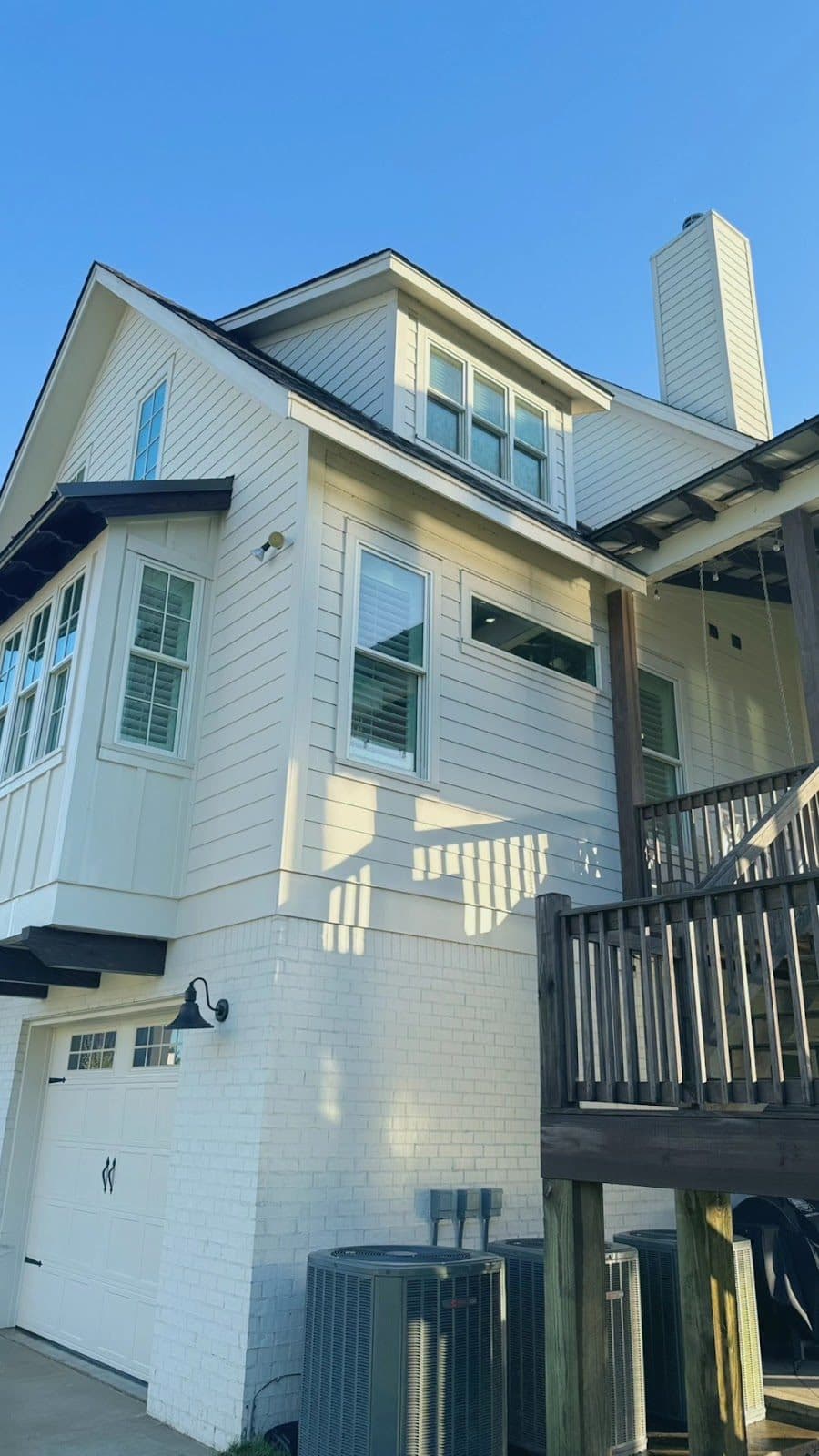 White two story home with a deck after a house wash, Birmingham metro